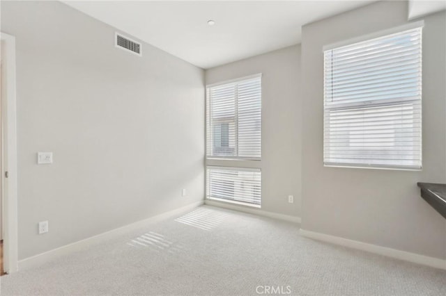 unfurnished room featuring light colored carpet