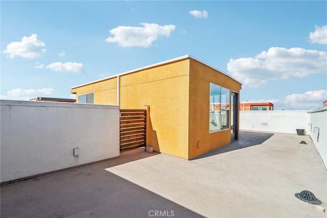 view of side of home featuring a patio