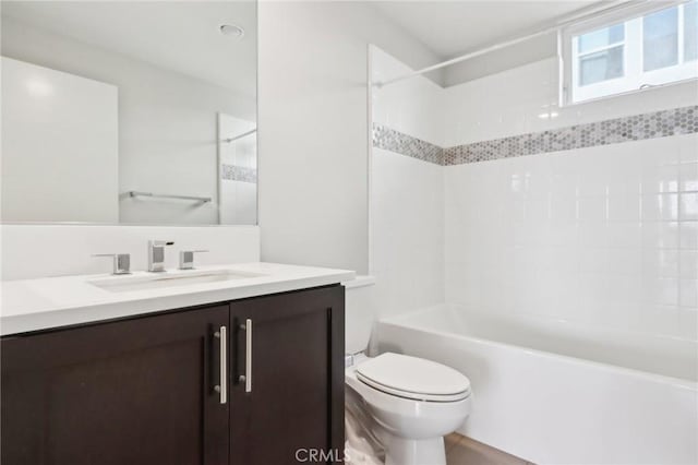 full bathroom featuring toilet, vanity, and tiled shower / bath