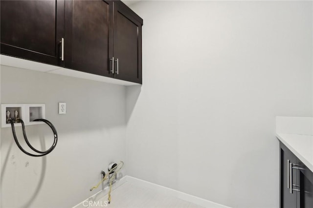 clothes washing area featuring cabinets, hookup for a washing machine, and hookup for a gas dryer