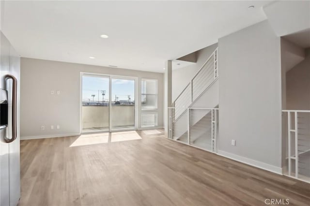 unfurnished living room featuring wood-type flooring