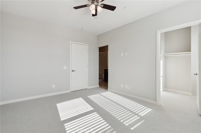 unfurnished bedroom featuring a closet, light colored carpet, and ceiling fan