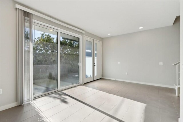 spare room with light tile patterned floors