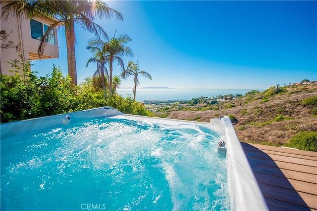 view of pool with an outdoor hot tub