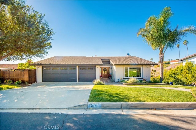 view of front of home featuring a garage and a front lawn