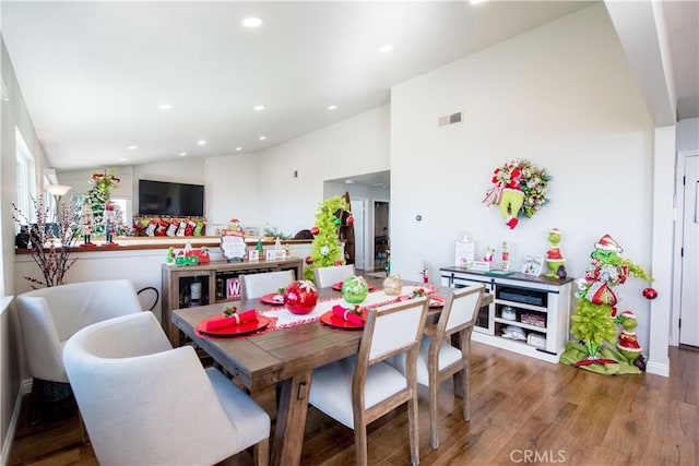 dining area with hardwood / wood-style flooring and lofted ceiling