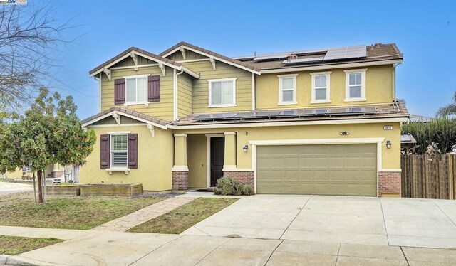 view of front of home with solar panels and a garage