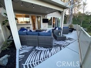 view of patio featuring outdoor lounge area and a balcony