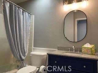 full bathroom with toilet, vanity, and shower / tub combo with curtain