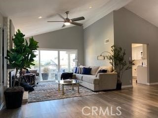 living room featuring ceiling fan, lofted ceiling, and hardwood / wood-style floors