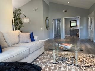 living room with wood-type flooring and high vaulted ceiling