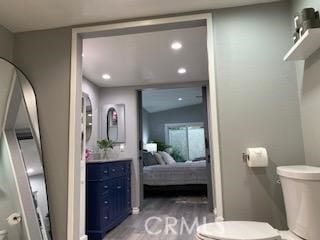 bathroom with hardwood / wood-style flooring and toilet