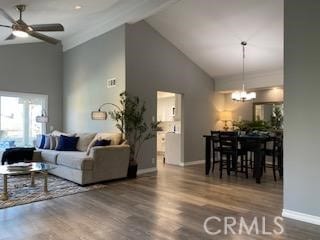 living room featuring high vaulted ceiling, hardwood / wood-style flooring, and ceiling fan with notable chandelier