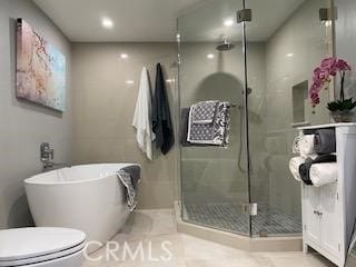 bathroom with toilet, tile patterned flooring, and separate shower and tub