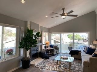 living room featuring ceiling fan, a wealth of natural light, lofted ceiling, and hardwood / wood-style floors