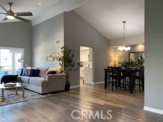 living room with high vaulted ceiling, ceiling fan with notable chandelier, and hardwood / wood-style flooring