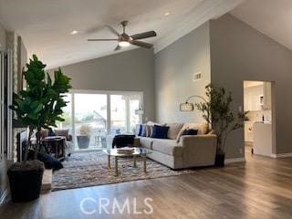 living room featuring ceiling fan, wood-type flooring, and lofted ceiling