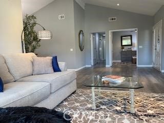 living room featuring high vaulted ceiling and wood-type flooring