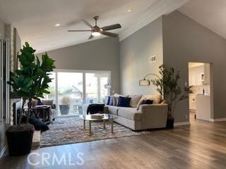 living room with vaulted ceiling, ceiling fan, and hardwood / wood-style flooring