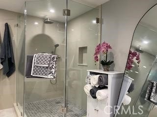 bathroom featuring a shower with door