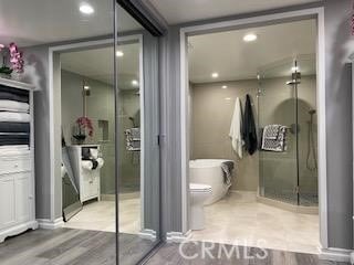 bathroom with toilet and hardwood / wood-style flooring