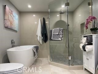 bathroom with tile patterned floors, toilet, and plus walk in shower