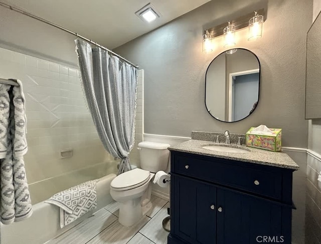 full bathroom featuring shower / bath combination with curtain, vanity, and toilet