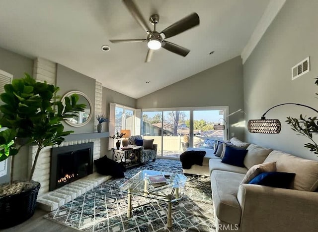 living room featuring a brick fireplace, high vaulted ceiling, and ceiling fan