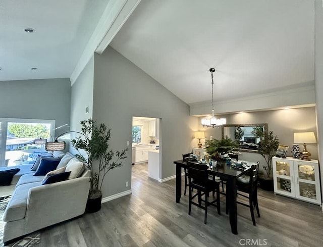 dining space with beamed ceiling, dark hardwood / wood-style flooring, a chandelier, and high vaulted ceiling