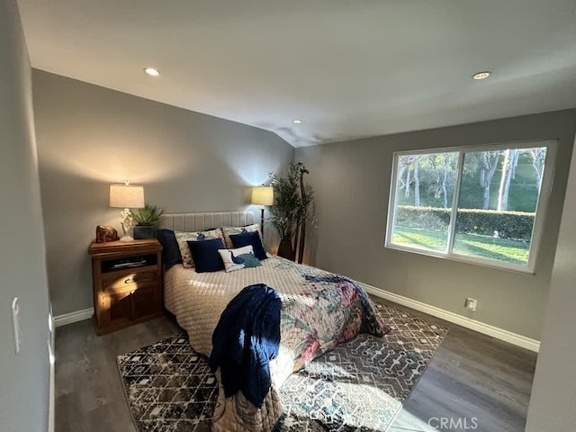 bedroom featuring dark wood-type flooring and vaulted ceiling