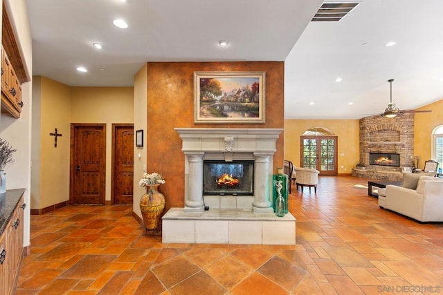 living room featuring a multi sided fireplace and ceiling fan