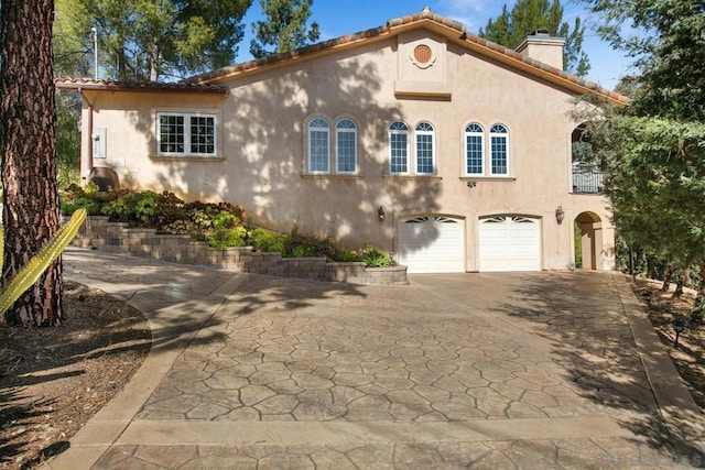 mediterranean / spanish house featuring a garage