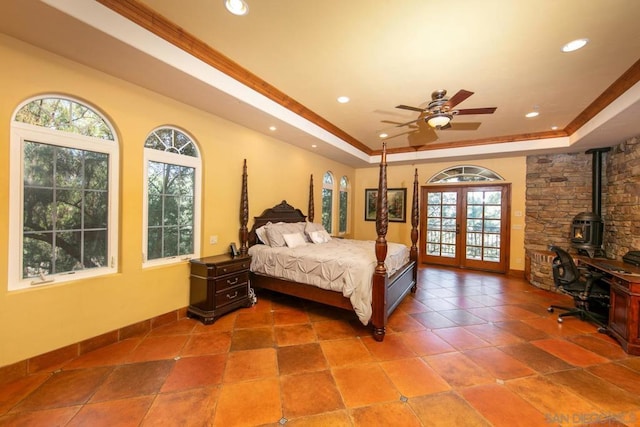 bedroom with a raised ceiling, crown molding, access to outside, and french doors