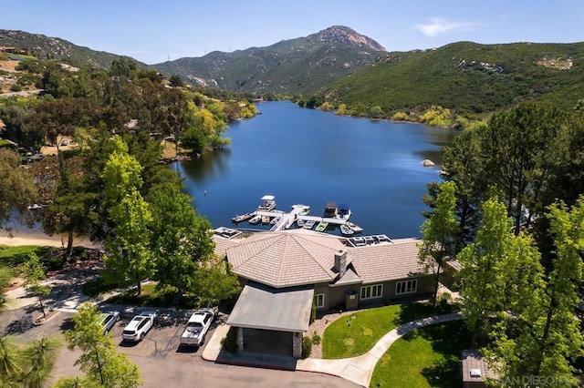 birds eye view of property with a water and mountain view