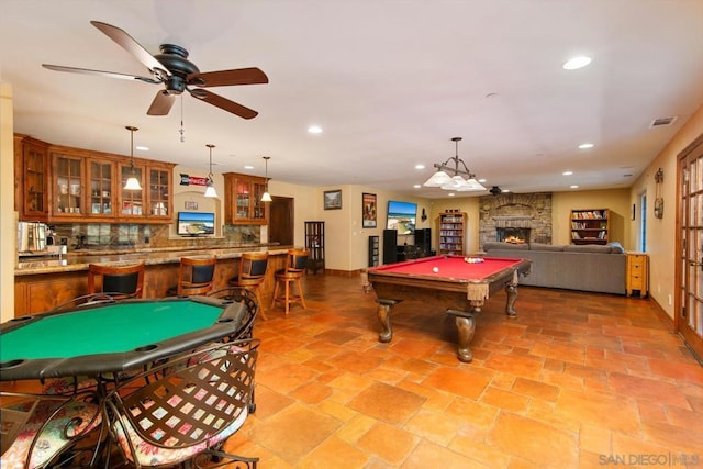 game room featuring ceiling fan, bar area, a fireplace, and billiards