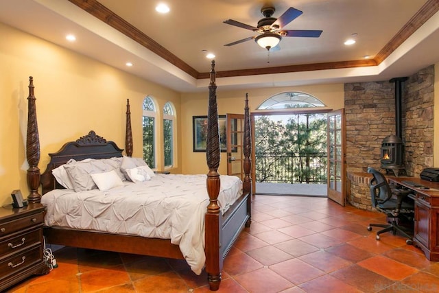 bedroom featuring ornamental molding, a raised ceiling, and access to outside