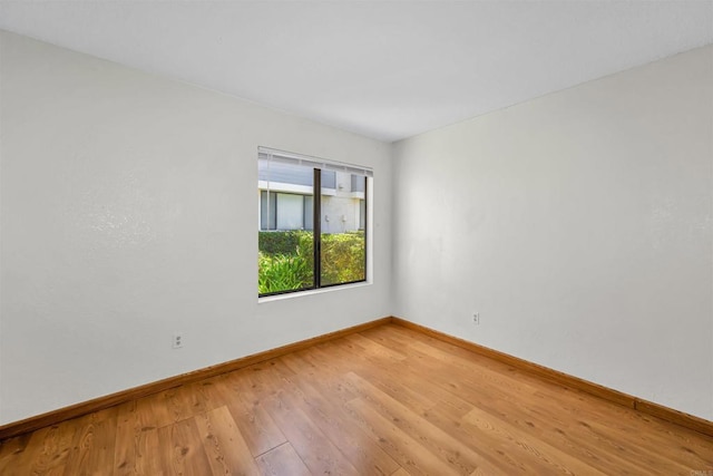 empty room with hardwood / wood-style floors