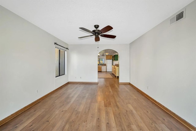 unfurnished living room with ceiling fan and light hardwood / wood-style flooring