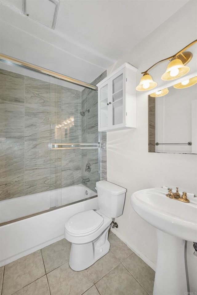 full bathroom with tile patterned flooring, combined bath / shower with glass door, sink, and toilet