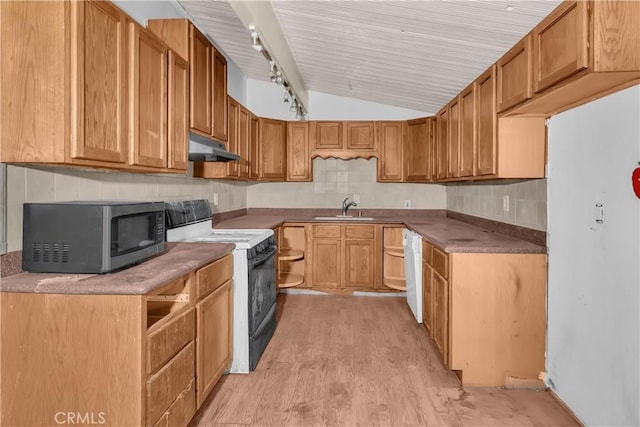 kitchen with light wood-type flooring, rail lighting, vaulted ceiling, sink, and black / electric stove