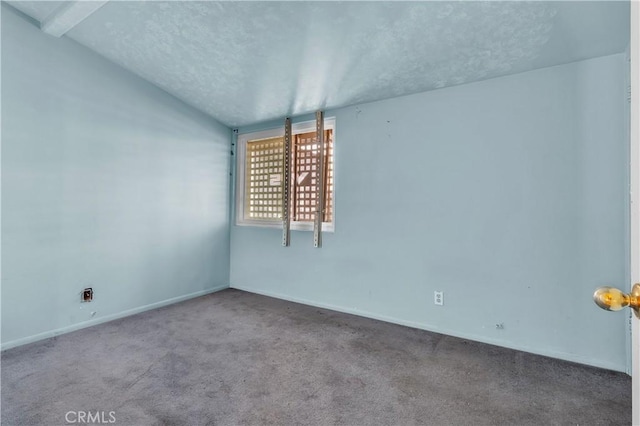 carpeted empty room with a textured ceiling