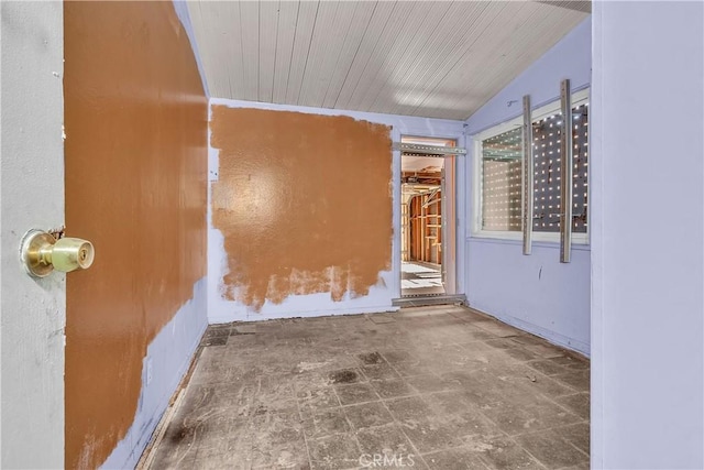 empty room with lofted ceiling