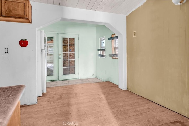 interior space with light hardwood / wood-style flooring and wooden ceiling