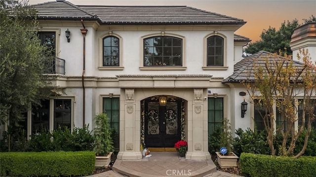 exterior entry at dusk with french doors