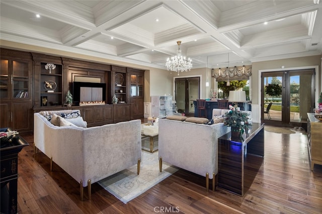 living room featuring beam ceiling, an inviting chandelier, coffered ceiling, dark wood-type flooring, and french doors