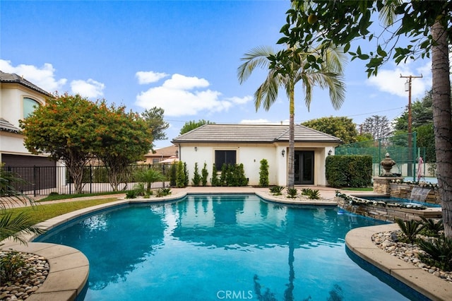 view of swimming pool with an in ground hot tub and an outdoor structure