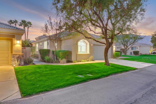 view of front of property featuring a yard and a garage