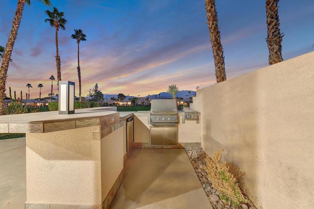 patio terrace at dusk with area for grilling and grilling area