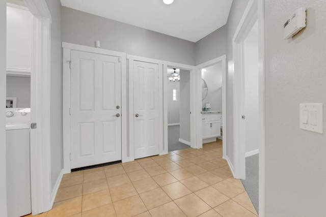 foyer featuring washer / clothes dryer and light tile patterned floors