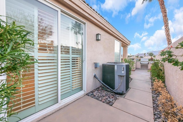 view of patio / terrace featuring central AC unit and exterior kitchen